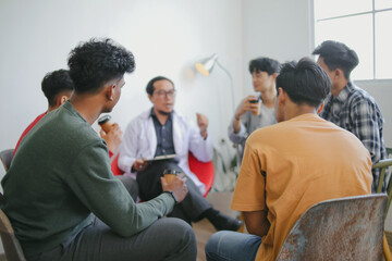 Fototapeta premium The Caregiver Therapist Sits With Group Of Diverse People In A Circle For Checking Physical And Mental Health On Group Therapy Session