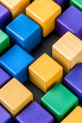 Obraz premium Colorful wooden blocks arranged in a diagonal pattern on a dark background