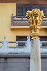 The Golden Lion Capital atop a Stone Column is beautifully set against a captivating backdrop