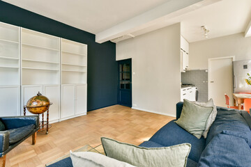 A stylish modern interior showcasing minimalist design elements with a cozy seating area and open layout, featuring neutral colors and natural light.
