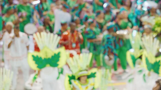 Brazilian carnival. Naturally blurred footage of the brazilian carnival and parade of school of samba performing on a sambodrome. People dance and celebrate on night parade of school of samba