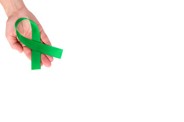 Green satin ribbon on the palm of a woman, isolated on a white background. Cancer awareness symbol....