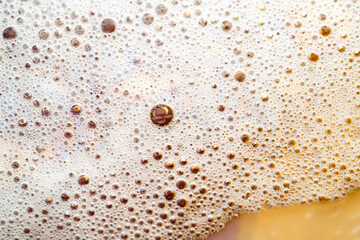 abstract foam and bubbles background on gold yellow, full frame, copy space