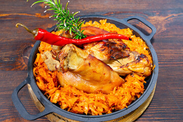 Delicious fried shank served with spiced carrot rice and herbs