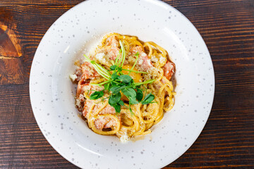 Creamy pasta with fresh herbs, served at a restaurant