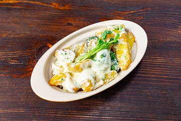 Creamy potato and broccoli dish served on a rustic wooden table