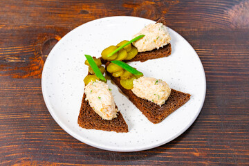 Unique hors d'oeuvres featuring dark bread and chicken spread