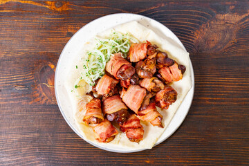 Deliciously grilled bacon-wrapped meat served on a plate