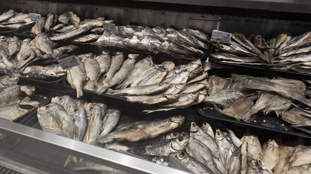 Sale of dried fish in the department in the store. Carp, crucian carp and roach.