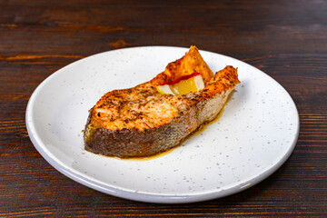 Grilled salmon fillet served on a white plate