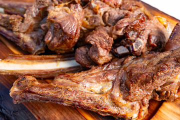 Deliciously grilled meat served on a wooden board at a barbecue