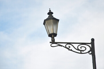 Vintage style street lamp against blue sky background. Vintage  street lantern isolated against blue sky background.
