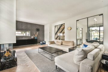 A contemporary living room featuring a stylish sofa, sleek decor, and elegant finishes, providing a welcoming and comfortable atmosphere.
