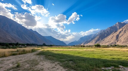 Scenic valley with sunbeams and clouds