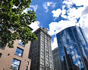 Naklejka premium three buildings of different architectural styles against a bright summer sky