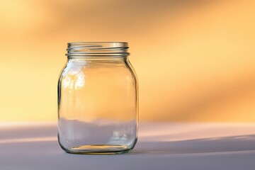 A Clear Empty Glass Jar Sitting on a Light Surface