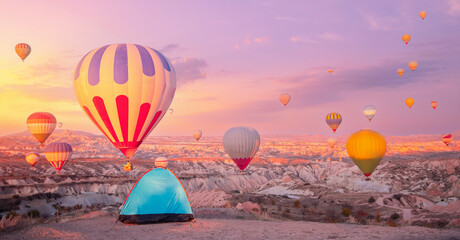 Travel Camping in tent in Cappadocia Turkey colorful hot air balloons at sunrise © Parilov