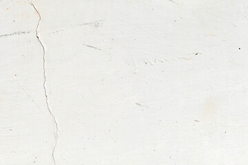 Dirty old white paint wall peeling cracked uneven weathered texture background. Stains on grunge and rough surface.