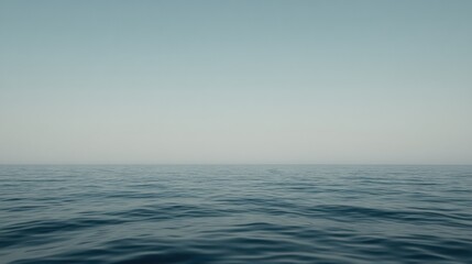 Fototapeta premium Calm Ocean Horizon Under a Pale Blue Sky