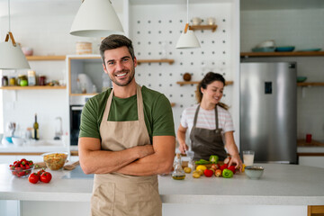 Professional personal chef cook in customer's private kitchen, giving a cooking lesson to people