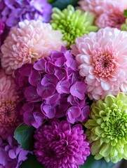 Obraz premium Vibrant Arrangement of Various Spring Flowers in Shades of Purple, Pink, and Green Creating a Colorful Floral Display for Celebrations or Decorations