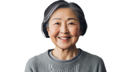 Elderly woman smiling warmly while wearing a cozy sweater against a plain background in natural light