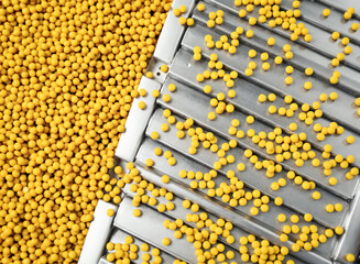 Obraz premium vibrant yellow spheres cascading onto a sleek metallic surface