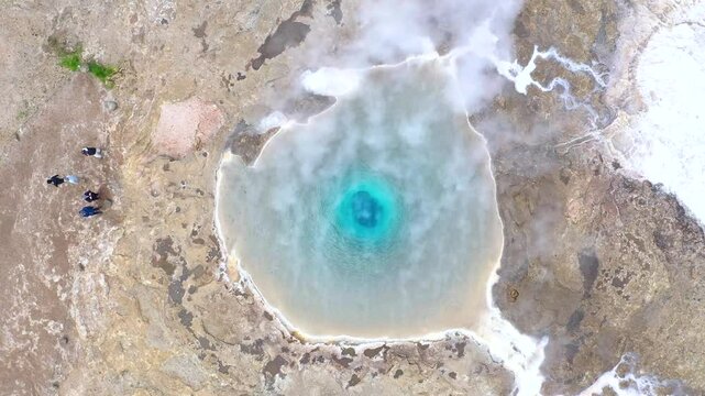 Flying above the Great Geyser, geysir in the Golden Circle, Iceland, slow motion aerial view