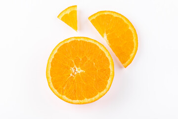 Top view of a halved orange, a slice and a wedge isolated on a white background, highlighting its bright color and juicy texture. Copy space. Fruit and food concept