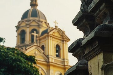 A yellow building with a clock tower in the background