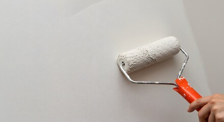 Obraz premium Painting a Wall with a Roller