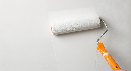 Obraz premium Painting a Wall: A Close-Up of a Paint Roller Applying Fresh White Paint