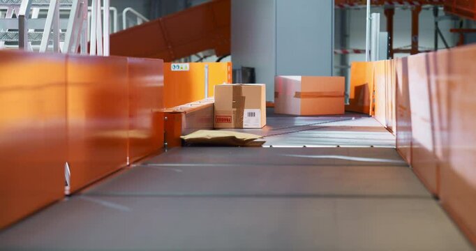 Private and Retail Parcels Navigate an Automated Conveyor Line in a Sorting Center, Ready to be Delivered. Logistics System Operation Flow and Package Handling in a Warehouse