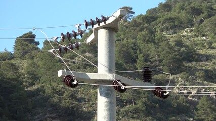 Fethiye, Turkey - 7th of May 2023: 4K Distribution electric pole and wires against forest
