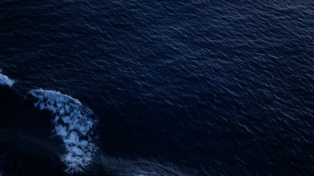 view to the waves rippling on water surface while cruising in the ocea sea in night dar time, wirling water while cruising, wave on sea water surface background in tropical sea.