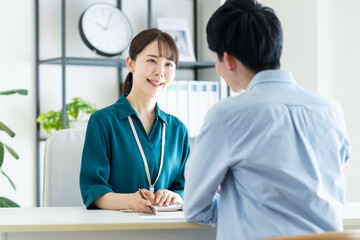 若い男性に営業するビジネスウーマン