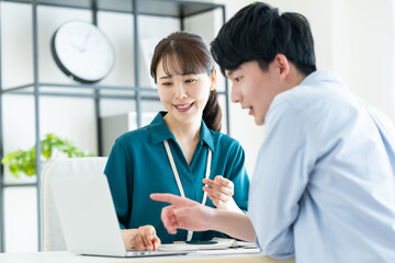 Obraz premium 若い男性に営業するビジネスウーマン