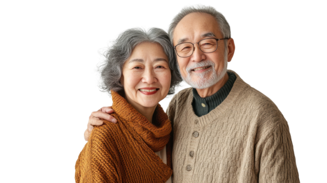 Elderly couple smiling warmly while embracing each other in a cozy indoor setting during daylight