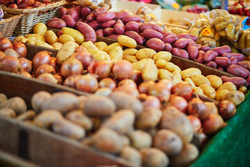 Large heap of fresh ripe organic potatoes on farmer market in Paris, France.