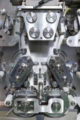 Close-up view of clean metal industrial dumpling and ravioli making machine in food processing factory or in modern commercial kitchen. Soft focus. Food technology theme.