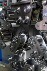 Close-up view of clean metal industrial dumpling and ravioli making machine in food processing factory or in modern commercial kitchen. Soft focus. Food technology theme.