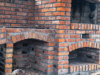 old gazebo. stone barbecue. Burning stone barbecue firewood with fire, open brick oven for cooking food meat fish, other dishes indoors in backyard. Restaurant kitchen, Interior construction