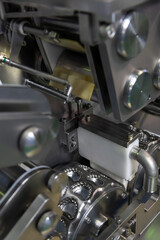 Obraz premium Close-up view of clean metal industrial dumpling and ravioli making machine in food processing factory or in modern commercial kitchen. Soft focus. Food technology theme.