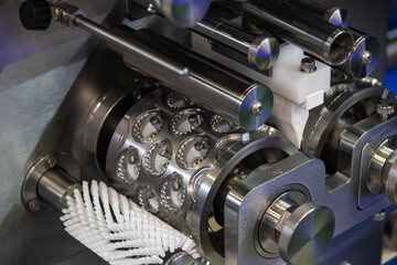 Close-up view of clean metal industrial dumpling and ravioli making machine in food processing factory or in modern commercial kitchen. Soft focus. Food technology theme.