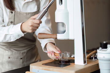 Espresso Making and Precision. A barista pulling a coffee shot at a state-of-the-art espresso machine.