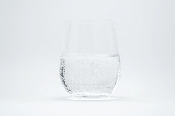 Clear sparkling water isolated on white background, Selective focus glass of soda water on white background.