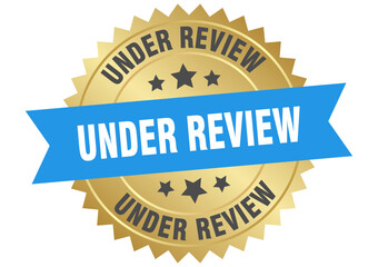 under review. under review round blue and gold label isolated on transparent background