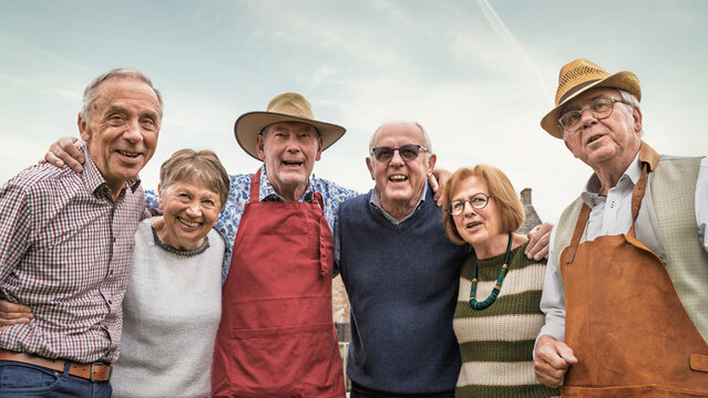 Senior friends smiling together outdoors showing friendship and community