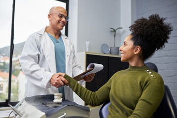 Fototapeta premium Professional Dentist Discussing Treatment Plan With a Smiling Female Patient in a Modern Dental Clinic