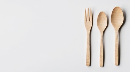 Minimalistic arrangement of wooden utensils on clean background